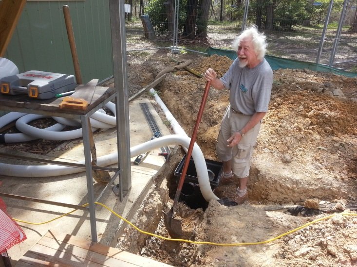 Shed member working in a trench installing eco stormwater drainage pipework