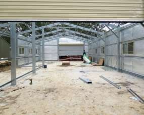 Steel frame of Block B with roof largely complete, nearing lock-up stage